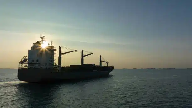 Ocean freight ship transporting containers, symbolic of long-haul shipping prior to local drayage delivery.