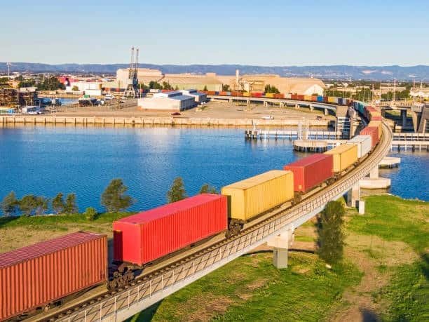 Cargo train transporting containers near an Australian port city