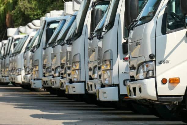 Line of white freight trucks used for inland transport and final delivery