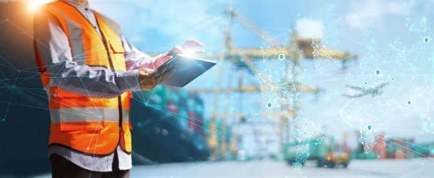 Supply chain professional using digital tablet for global logistics tracking