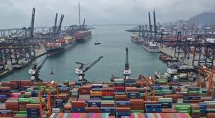 Busy Hong Kong container port showing cargo handling and international shipping activity.