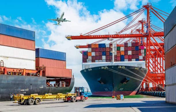 Container ship docked at international port with airplane above, ready for China to Pakistan shipment