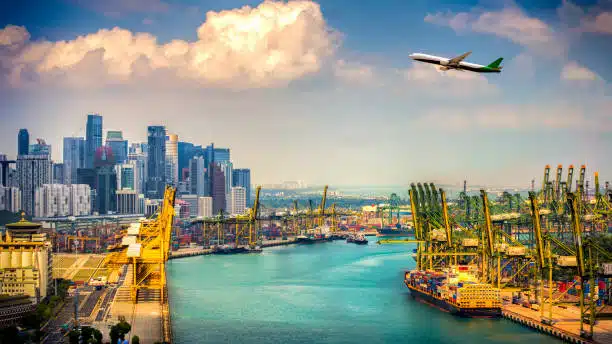 Airplane flying above a port full of containers being imported from China to Kenya