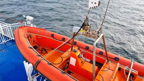 Lifeboat secured on cargo vessel for maritime safety under FOB terms