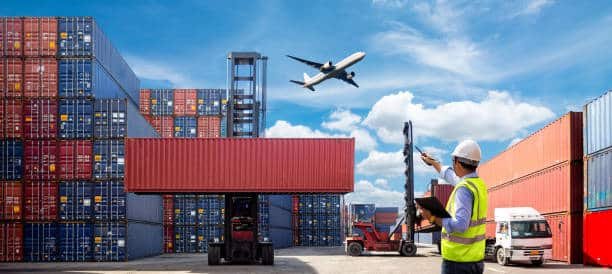 Worker supervising container loading and air freight shipment