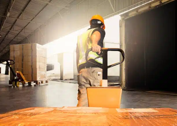 Worker loading pallets onto a truck for door-to-door delivery service
