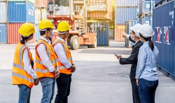 Logistics team briefing workers at a container yard for shipping from China to Somalia