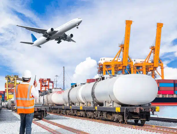 Tanker rail car and airplane at shipping terminal, managed by logistics staff for China to UK deliveries