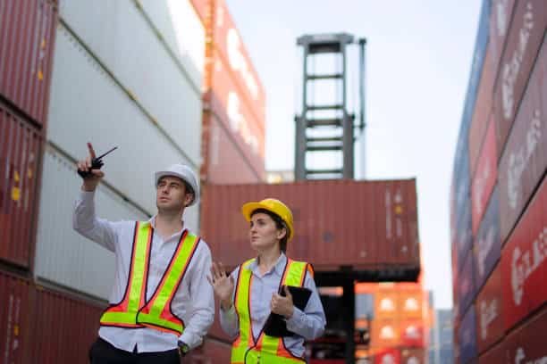 Freight inspectors reviewing container alignment at port terminal