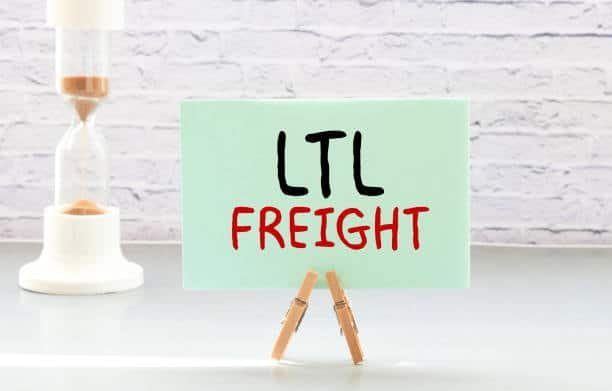 Sign with the text “LTL Freight” displayed on a desk with a timer in the background