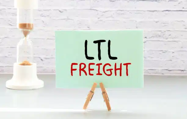 Sign with the text “LTL Freight” displayed on a desk with a timer in the background