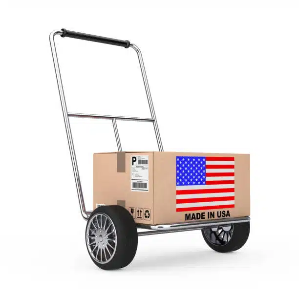 Box marked made in USA on trolley with shipping label for overseas delivery