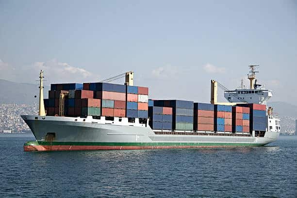 Container ship sailing with full cargo load calculated in twenty foot equivalent units