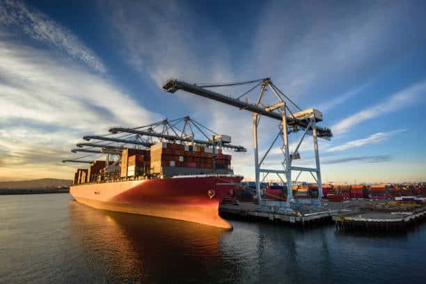 Large cargo vessel at port being loaded for shipment to Italy