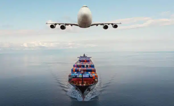 Airplane flying over cargo ship, symbolizing international freight transport