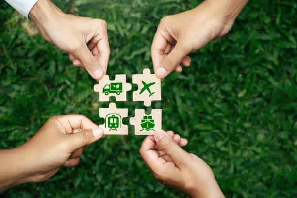 Hands assembling puzzle pieces representing truck, rail, air, and sea transport