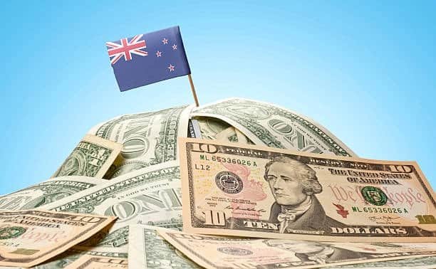 New Zealand flag on pile of US dollar bills representing courier costs and rates