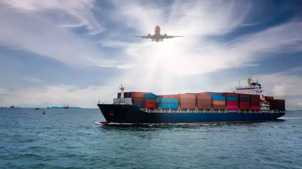 Cargo ship at sea with airplane overhead symbolizing multimodal transport to Mexico.