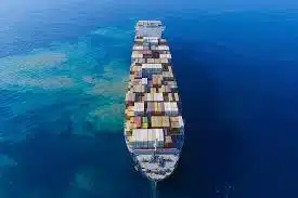 Cargo ship transporting containers across ocean for sea freight from China to Oman