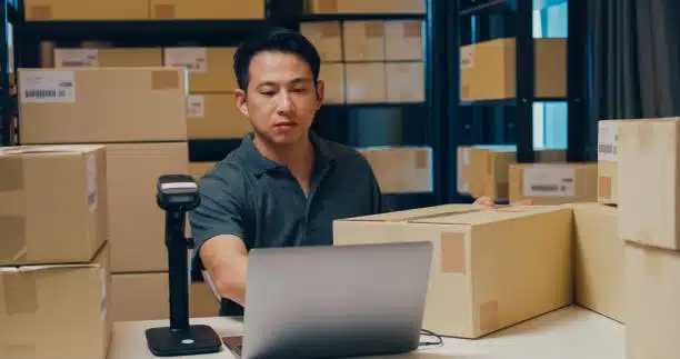 Worker scanning packages for tracking in door-to-door delivery system