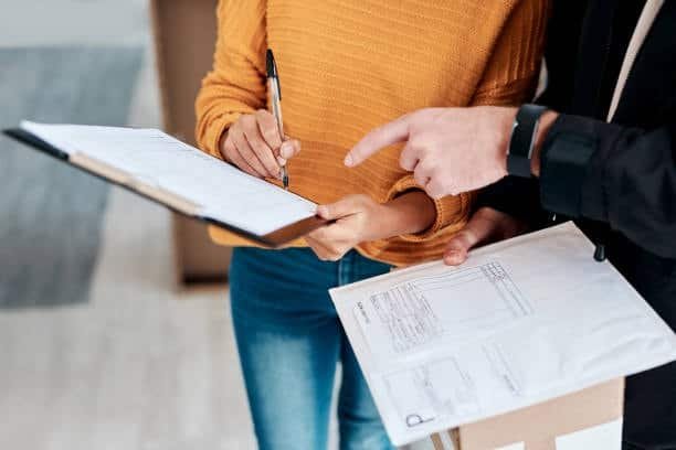 Customer signing package receipt during final stage of door-to-door delivery