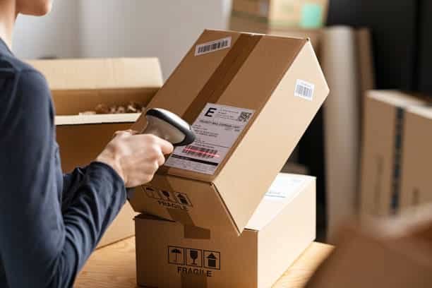 Handheld scanner checking export parcels for shipping to Argentina