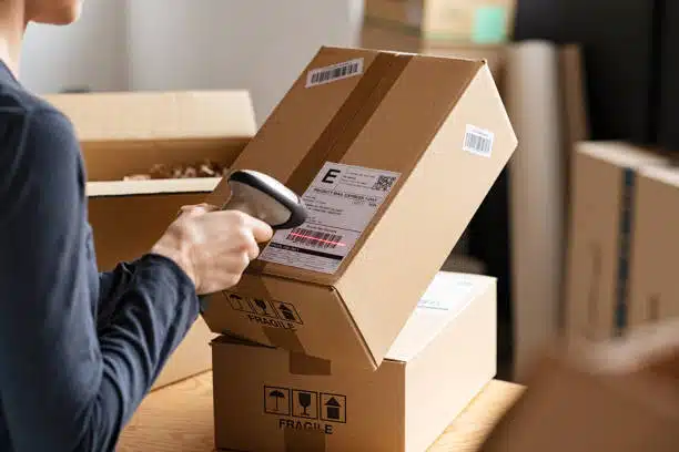 Handheld scanner checking export parcels for shipping to Argentina