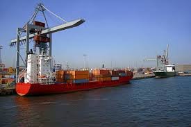 Cargo ship being loaded at port for shipping between China and Singapore.