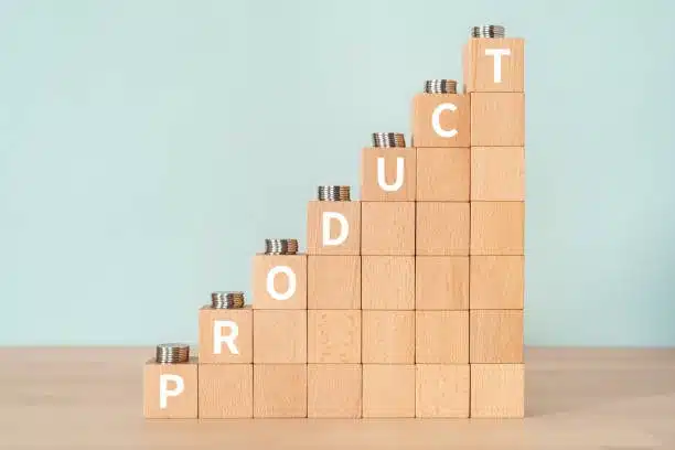 Product cost visual with stacked coins and wood blocks showing price increase