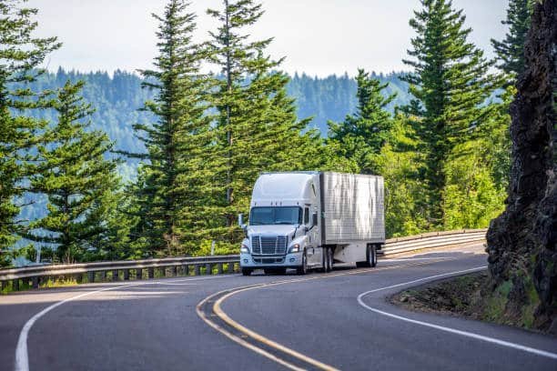 Freight truck driving on road as part of last-mile delivery in Sudan