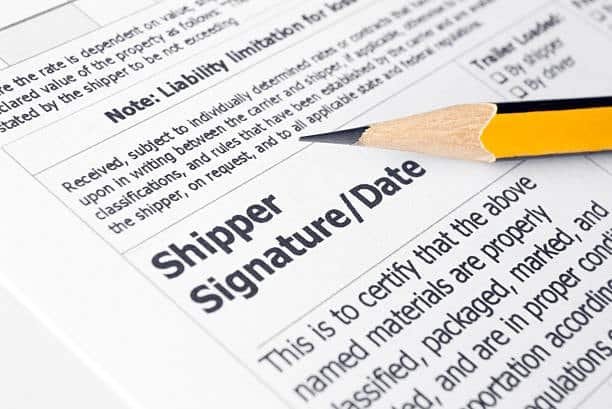Pencil pointing to shipper signature and date line on a bill of lading