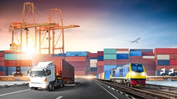Shipping containers, cargo truck, and freight train at port terminal for China to UK supply chain