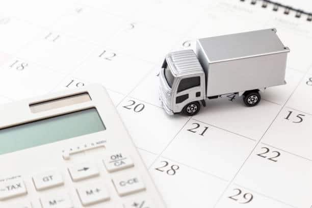 Delivery truck on a calendar with a calculator showing import timing and fees