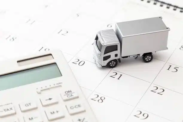 Delivery truck on a calendar with a calculator showing import timing and fees