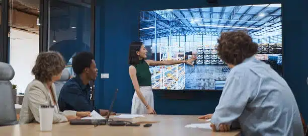 Business team watching a presentation on warehouse logistics and supply chain operations