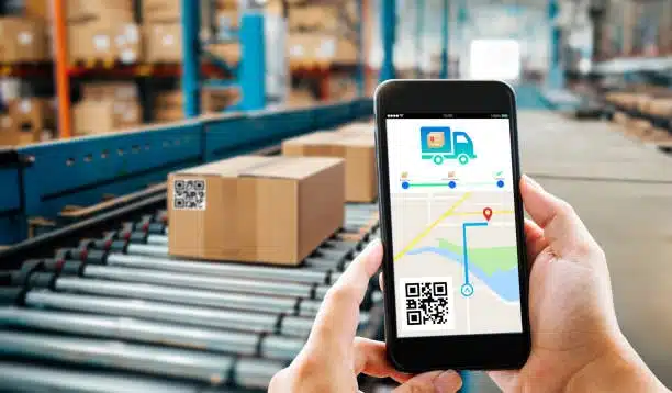 Person using a mobile app to track shipping parcels on a conveyor belt in a logistics warehouse