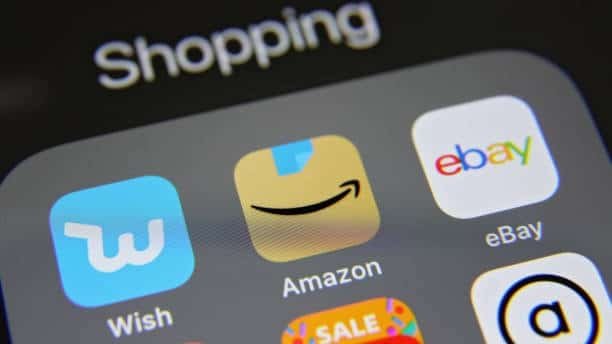 Smartphone screen showing shopping app icons including Amazon, Wish, and eBay