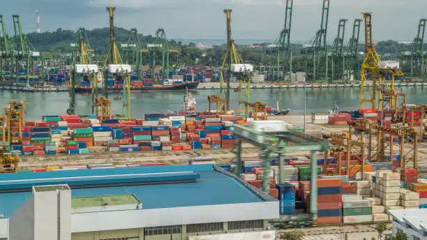 View of busy Singapore shipping terminal with port cranes and stacked containers