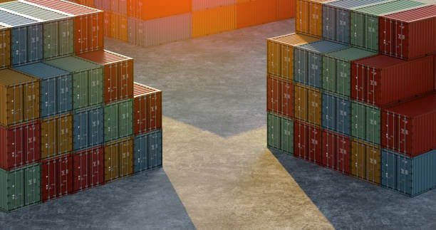 A storage yard filled with stacks of multicolored shipping containers, including red, blue, and green, under natural light.