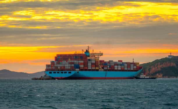 Large container ship arriving in Egypt at sunset, highlighting maritime shipping from China.