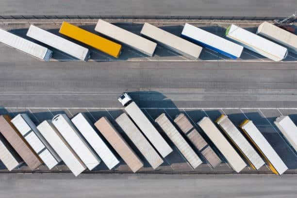 Aerial view of multiple container trucks parked in a logistics terminal