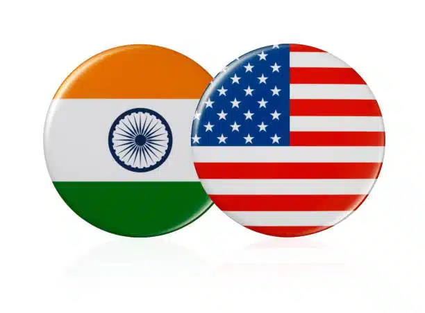 Round icons of USA and India flags symbolizing cross-border courier services