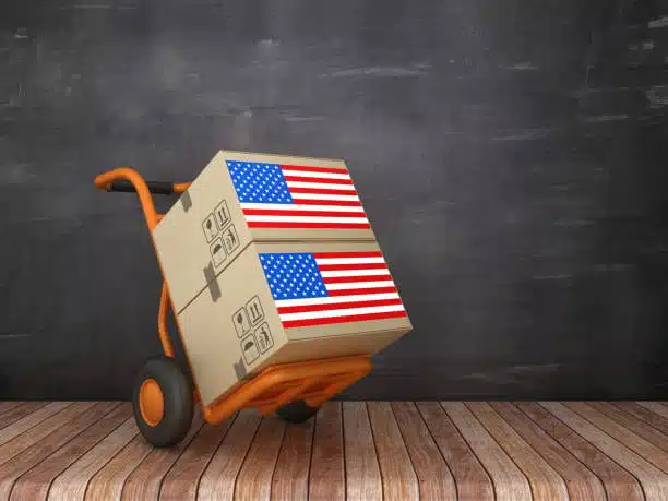 Cart loaded with USA-labeled packages symbolizing overseas shipping
