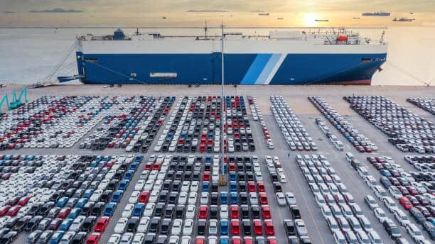 Cargo ship and rows of vehicles prepared for export