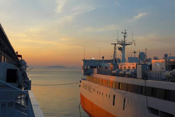 Cargo ship docked at destination port during evening under FOB arrangement