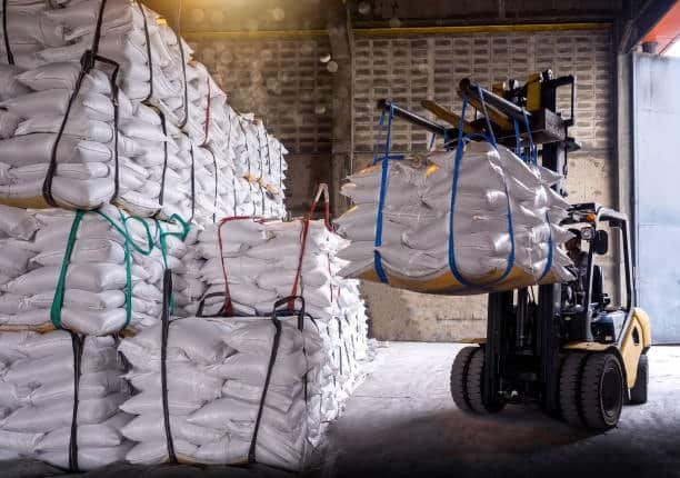 Forklift moving bundled goods inside a warehouse during toy shipping operations