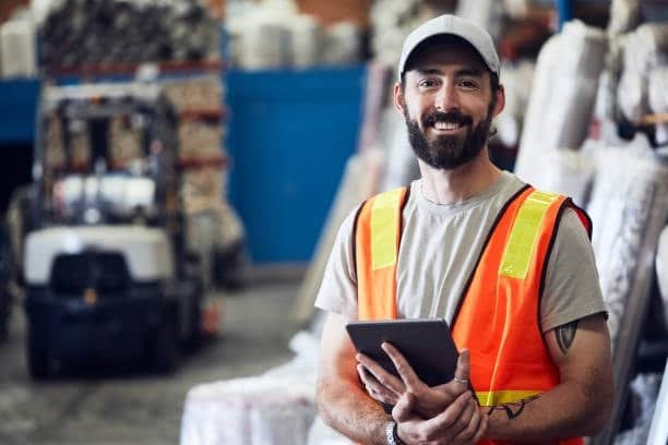Smiling warehouse worker managing export logistics for USA to Australia shipping