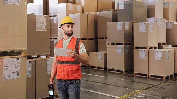 Logistics worker inspecting Brazil-bound imports in a warehouse setting
