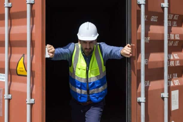 Worker unloading a shared container in an LCL shipping scenario, common in consolidated cargo logistics.