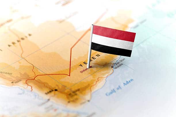 Yemen national flag pinned on a detailed map of the Arabian Peninsula